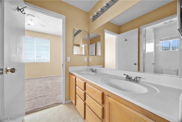 6088 Gulf Island Ave, Las Vegas, NV 89156 - bathroom featuring plenty of natural light, a ceiling fan, double vanity, and baseboards