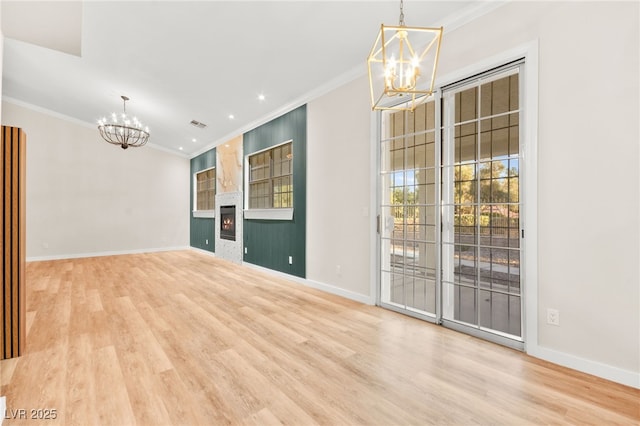 5009 Elm Grove Dr, Las Vegas, NV 89130 - unfurnished room featuring a chandelier, crown molding, wood finished floors, a fireplace, and baseboards