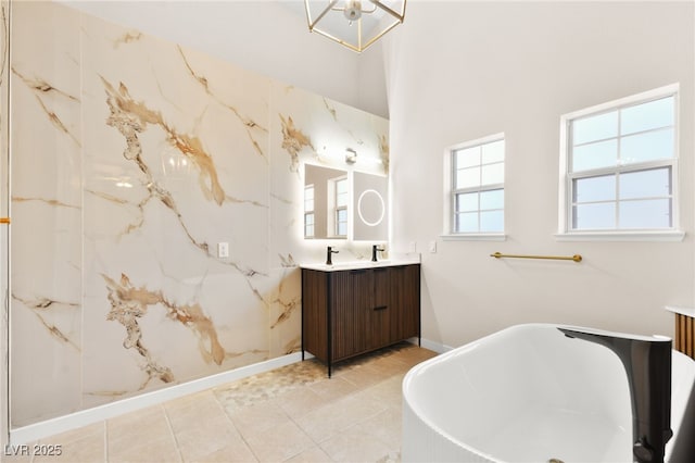 5009 Elm Grove Dr, Las Vegas, NV 89130 - full bath featuring vanity, a freestanding bath, baseboards, and a chandelier