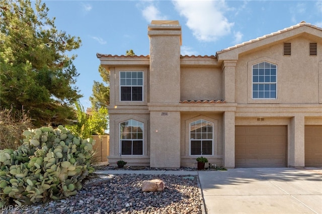 2834 Crystal Lantern Dr, Henderson, NV 89074 - view of front of house featuring driveway, an attached garage, a tile roof, stucco siding, and a chimney