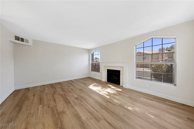 2834 Crystal Lantern Dr, Henderson, NV 89074 - unfurnished living room featuring light wood finished floors, baseboards, and a fireplace