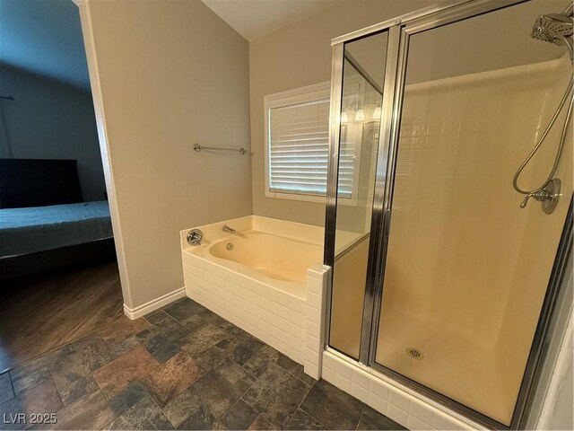 5318 Rio Eldorado Ct, North Las Vegas, NV 89031 - full bathroom with a stall shower, a bath, baseboards, ensuite bath, and stone finish floors