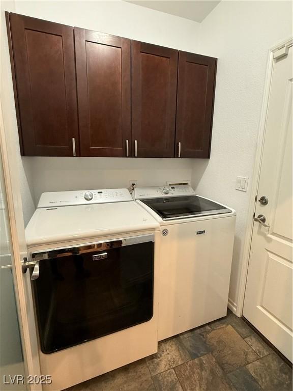 5318 Rio Eldorado Ct, North Las Vegas, NV 89031 - laundry area featuring washer and clothes dryer, cabinet space, and dark stone finish floors