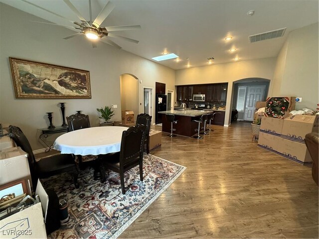 5318 Rio Eldorado Ct, North Las Vegas, NV 89031 - dining space featuring arched walkways, a ceiling fan, and wood finished floors