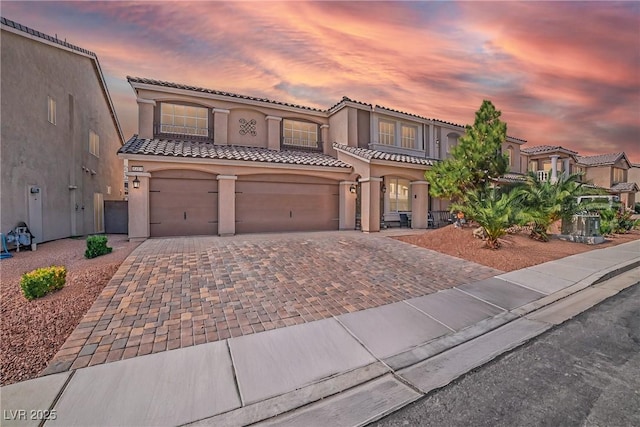 6453 Mount Eden Ave, Las Vegas, NV 89139 - mediterranean / spanish-style home with a tiled roof, driveway, and stucco siding