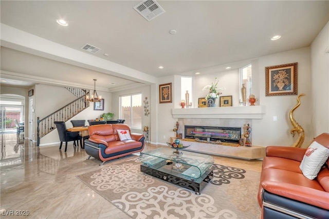 6453 Mount Eden Ave, Las Vegas, NV 89139 - living area featuring stairs, a chandelier, a tiled fireplace, recessed lighting, and marble tiled floors
