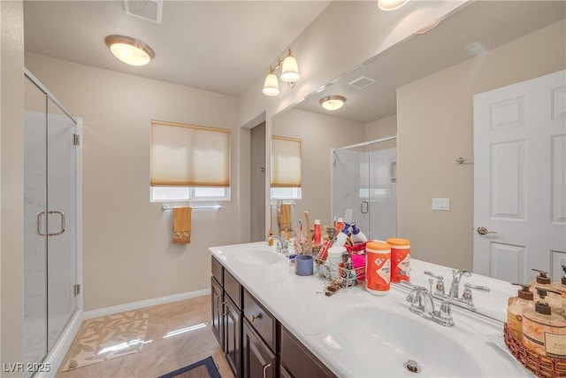 6453 Mount Eden Ave, Las Vegas, NV 89139 - full bathroom with a shower stall, double vanity, and baseboards