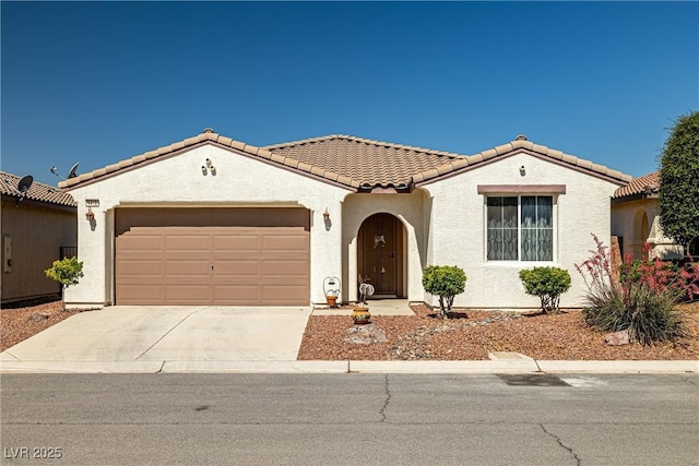 4410 S Gressa St, Pahrump, NV 89061 - mediterranean / spanish house featuring a tiled roof, stucco siding, driveway, and an attached garage
