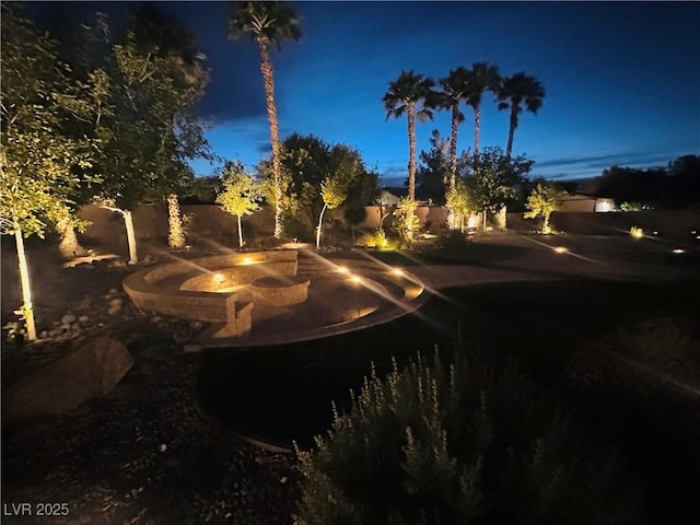8225 Fulton Ranch St, Las Vegas, NV 89131 - yard at twilight featuring a fire pit and a fenced backyard