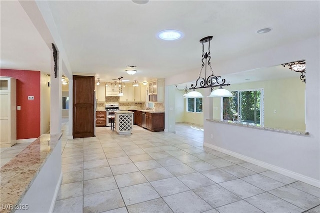 5159 N Monte Cristo Way, Las Vegas, NV 89149 - kitchen featuring range with two ovens, light tile patterned floors, light countertops, backsplash, and under cabinet range hood