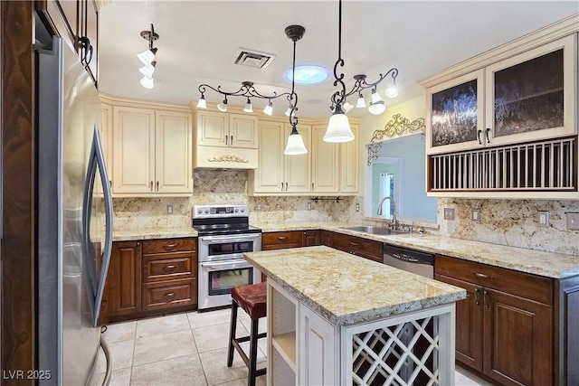 5159 N Monte Cristo Way, Las Vegas, NV 89149 - kitchen featuring stainless steel appliances, a sink, tasteful backsplash, a kitchen island, and hanging light fixtures