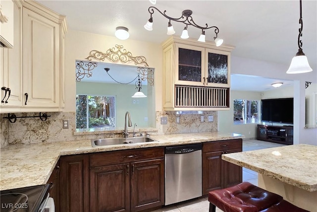 5159 N Monte Cristo Way, Las Vegas, NV 89149 - kitchen with a sink, dishwasher, stove, tasteful backsplash, and cream cabinets