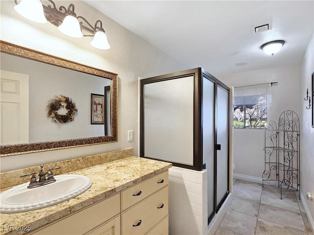 5159 N Monte Cristo Way, Las Vegas, NV 89149 - full bathroom featuring vanity, tile patterned floors, baseboards, and a stall shower