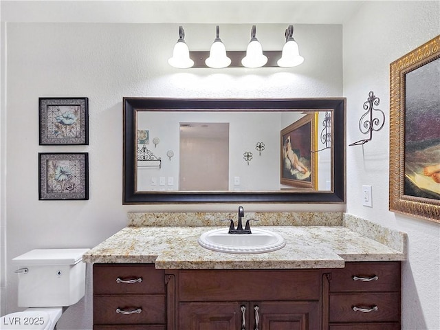 5159 N Monte Cristo Way, Las Vegas, NV 89149 - bathroom featuring vanity, toilet, and a textured wall