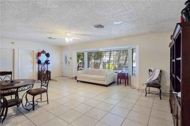 5159 N Monte Cristo Way, Las Vegas, NV 89149 - living room featuring a ceiling fan, light tile patterned floors, and a textured ceiling
