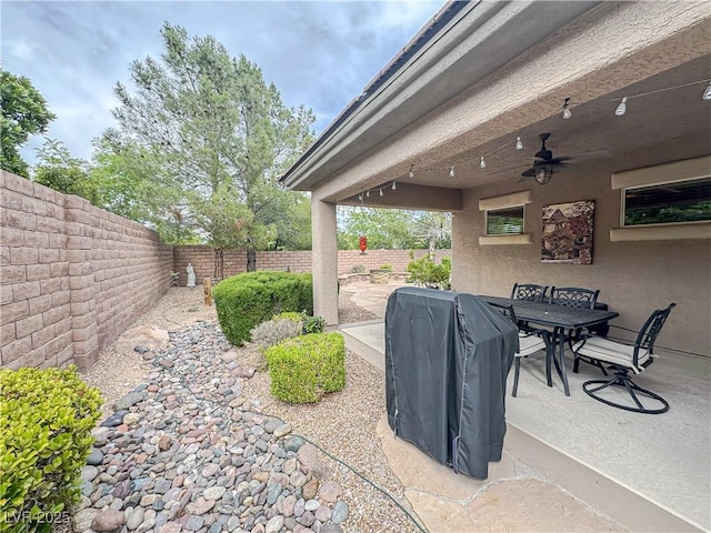 view of patio featuring a ceiling fan, a fenced backyard, grilling area, and outdoor dining space