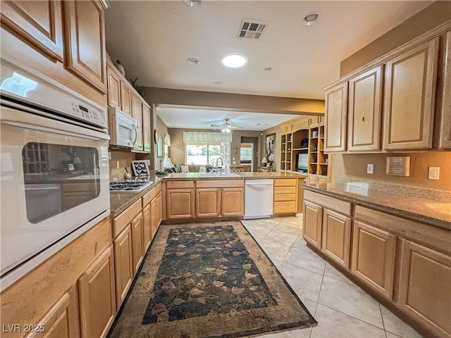 kitchen with white appliances, a peninsula, a ceiling fan, light tile patterned floors, and recessed lighting