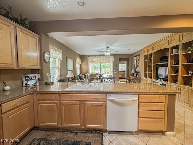 kitchen with white dishwasher, a sink, a ceiling fan, open floor plan, and light tile patterned floors