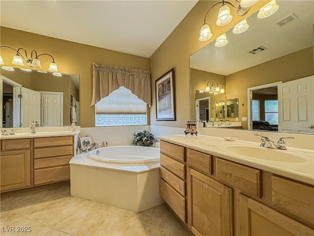 bathroom featuring healthy amount of natural light, tile patterned flooring, a bath, and two vanities