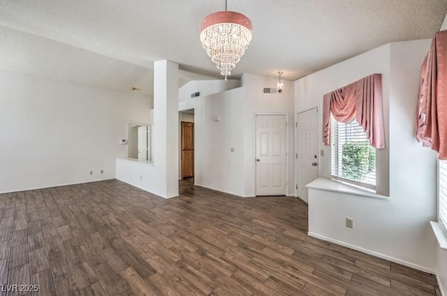 2753 Port Of Call Dr, Las Vegas, NV 89128 - empty room with a chandelier, dark wood-style flooring, baseboards, and vaulted ceiling