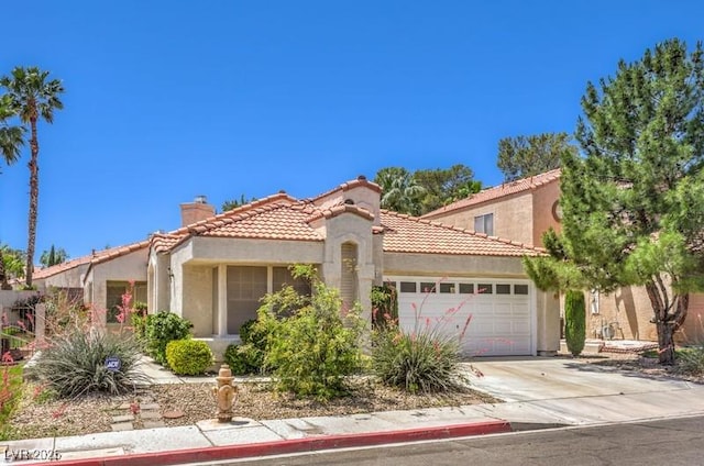 2753 Port Of Call Dr, Las Vegas, NV 89128 - mediterranean / spanish-style house featuring a chimney, a tiled roof, an attached garage, concrete driveway, and stucco siding
