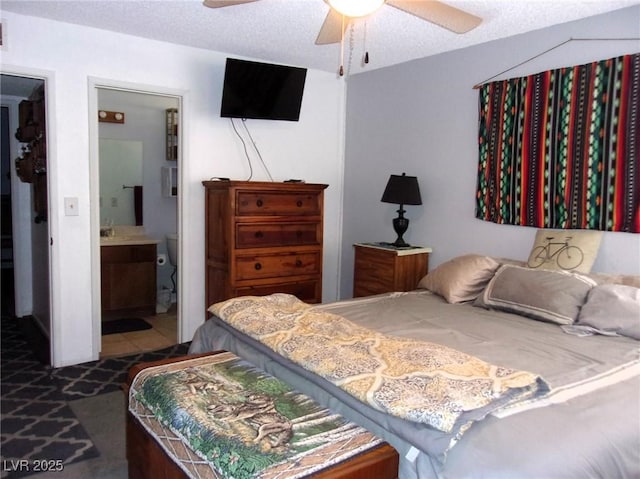 3720 Desert Marina Dr Unit 33, Laughlin, NV 89029 - bedroom with connected bathroom, ceiling fan, and a textured ceiling