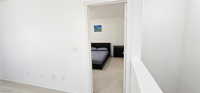 hallway featuring carpet floors and baseboards