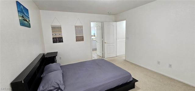bedroom featuring baseboards and light colored carpet