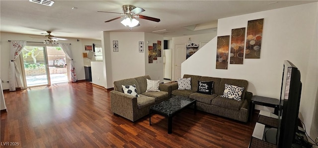living area with ceiling fan, dark wood-style flooring, and baseboards