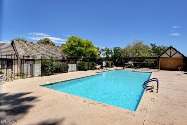 community pool featuring fence and a patio area