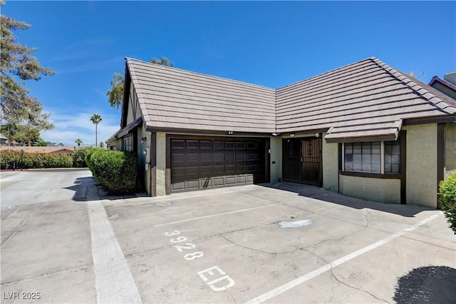 view of front of home featuring stucco siding and a tiled roof