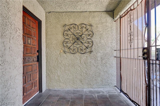entrance to property with stucco siding
