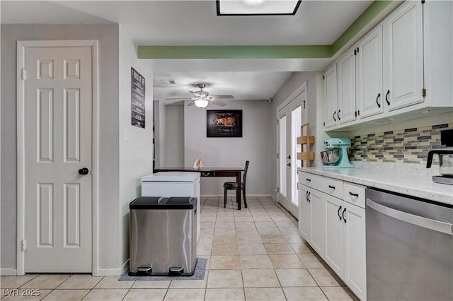 kitchen featuring dishwasher, light tile patterned flooring, white cabinets, and tasteful backsplash