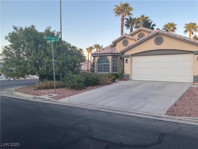 1800 Quail Point Ct, Las Vegas, NV 89117 - mediterranean / spanish house with an attached garage, stucco siding, driveway, and a tiled roof