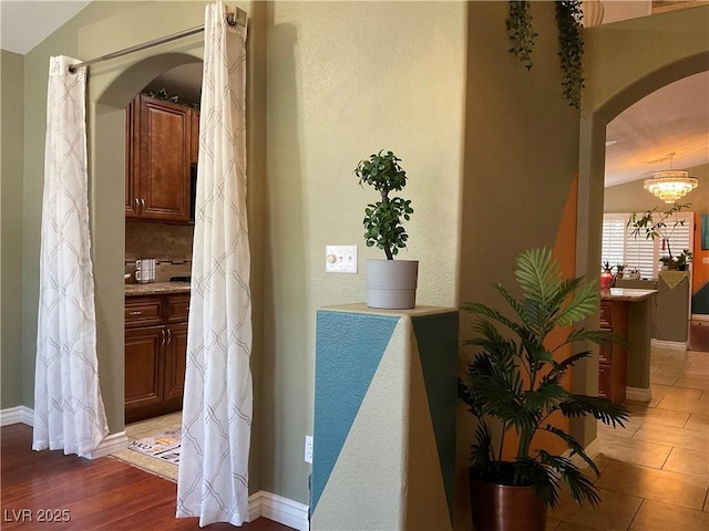 1800 Quail Point Ct, Las Vegas, NV 89117 - hall with arched walkways, baseboards, and a chandelier