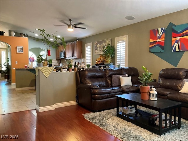 1800 Quail Point Ct, Las Vegas, NV 89117 - living room featuring a ceiling fan, arched walkways, wood finished floors, and baseboards