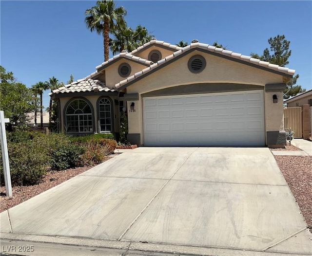 1800 Quail Point Ct, Las Vegas, NV 89117 - mediterranean / spanish home featuring a tile roof, stucco siding, a garage, and driveway