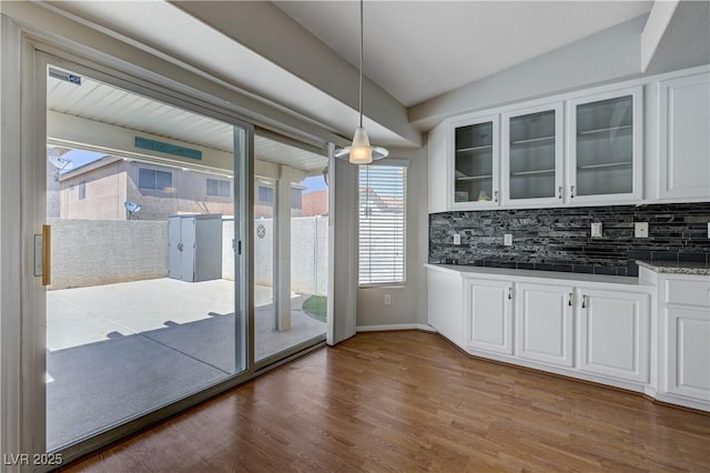472 Staghorn Pass Ave, Las Vegas, NV 89183 - unfurnished dining area with plenty of natural light, dark wood-style flooring, lofted ceiling, and baseboards