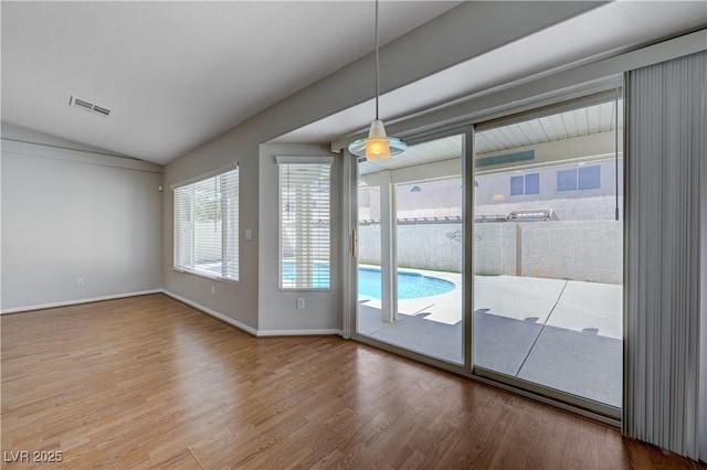 472 Staghorn Pass Ave, Las Vegas, NV 89183 - unfurnished room featuring lofted ceiling, wood finished floors, and baseboards