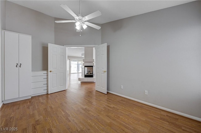 472 Staghorn Pass Ave, Las Vegas, NV 89183 - unfurnished bedroom with high vaulted ceiling, wood finished floors, baseboards, ceiling fan, and a closet