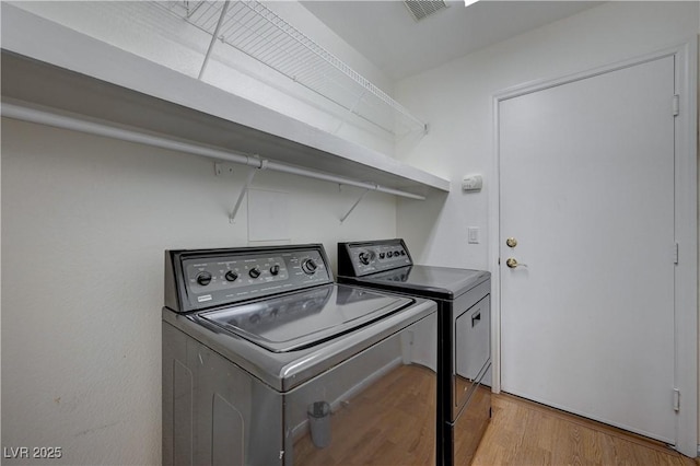 472 Staghorn Pass Ave, Las Vegas, NV 89183 - washroom featuring washer and clothes dryer and wood finished floors