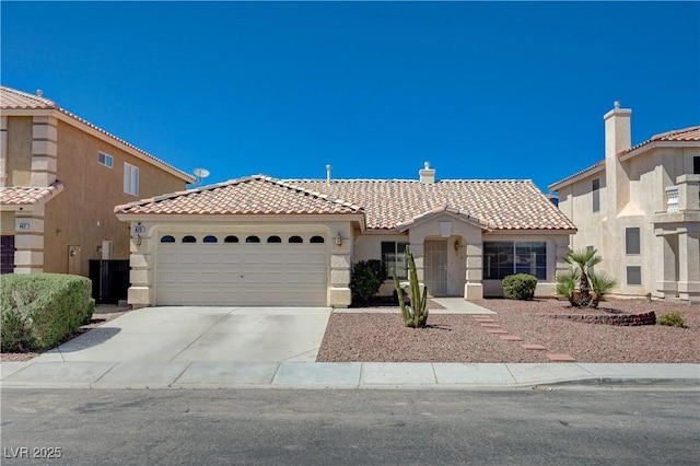 472 Staghorn Pass Ave, Las Vegas, NV 89183 - mediterranean / spanish-style house with a tile roof, stucco siding, a garage, and concrete driveway
