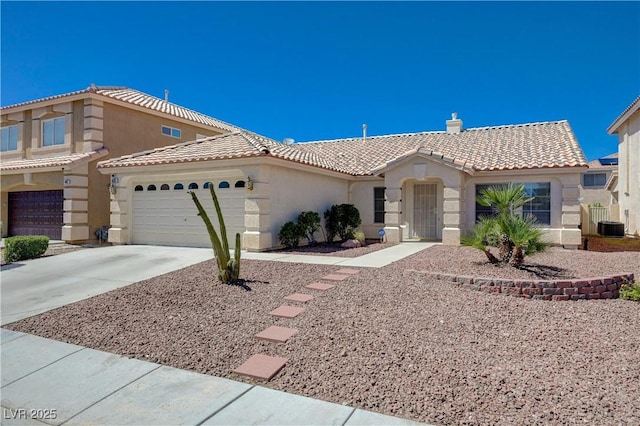 472 Staghorn Pass Ave, Las Vegas, NV 89183 - view of front of home with a tiled roof, stucco siding, driveway, an attached garage, and cooling unit