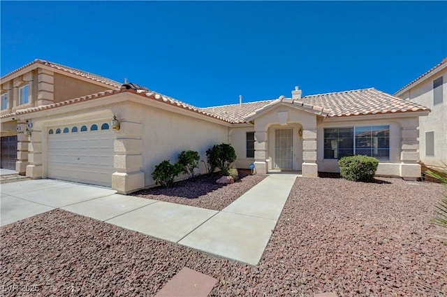 472 Staghorn Pass Ave, Las Vegas, NV 89183 - view of front of house featuring a tile roof, stucco siding, driveway, and an attached garage