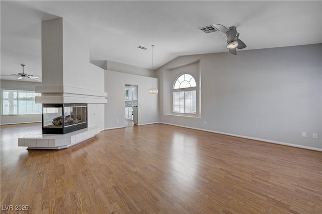 472 Staghorn Pass Ave, Las Vegas, NV 89183 - unfurnished living room featuring a ceiling fan, plenty of natural light, wood finished floors, and high vaulted ceiling
