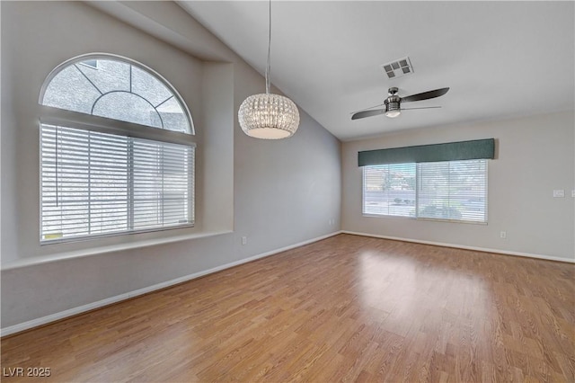 472 Staghorn Pass Ave, Las Vegas, NV 89183 - spare room with wood finished floors, ceiling fan, lofted ceiling, baseboards, and a chandelier