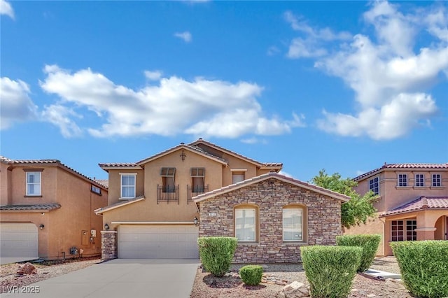 3217 Bonassola Ave, North Las Vegas, NV 89031 - mediterranean / spanish-style home with an attached garage, stucco siding, concrete driveway, stone siding, and a tiled roof