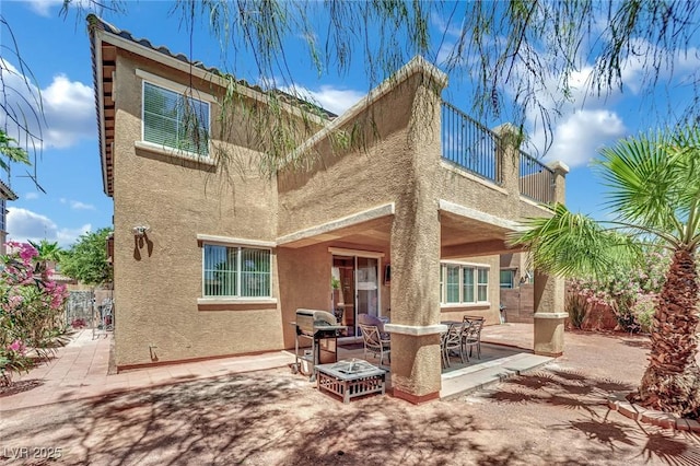 3217 Bonassola Ave, North Las Vegas, NV 89031 - back of house with stucco siding, a patio area, and a balcony