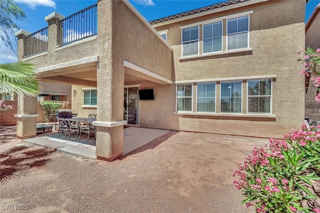 3217 Bonassola Ave, North Las Vegas, NV 89031 - back of property with stucco siding, a patio, and a balcony