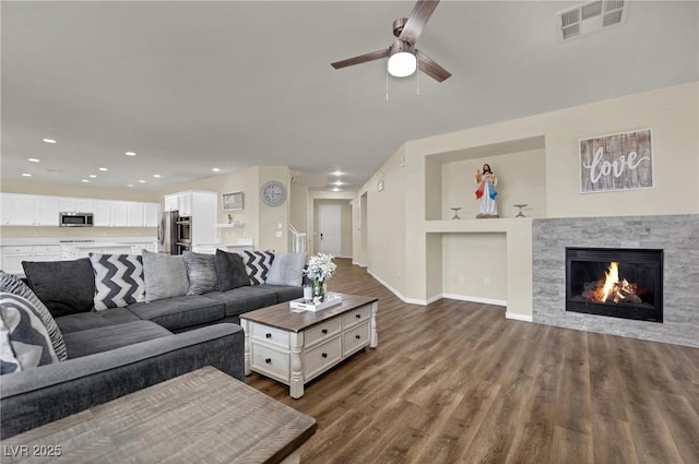 3217 Bonassola Ave, North Las Vegas, NV 89031 - living room featuring ceiling fan, dark wood-style floors, a fireplace, recessed lighting, and built in shelves